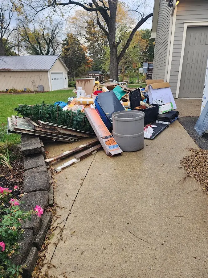 Dumpster being loaded with debris for Demolition Dumpster Rental in Sandusky